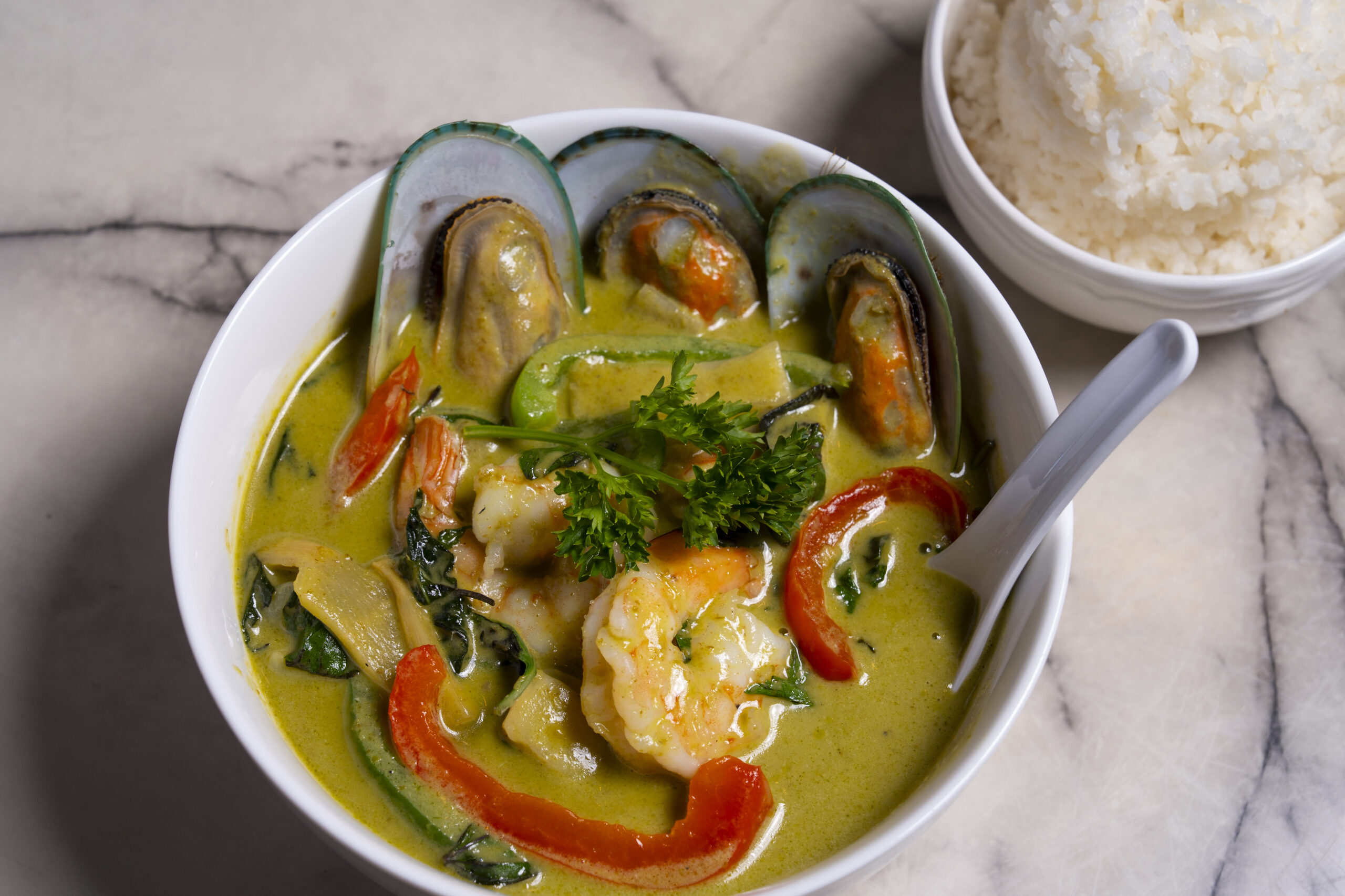Close-up of a flavorful Thai green curry with chicken.